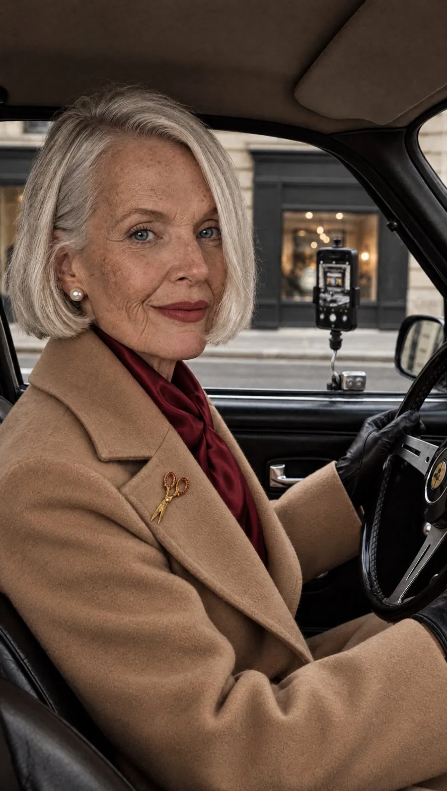 Margot in a camel coat in a car
